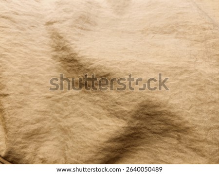 Brown polyamide fabric texture background with high contrast and sharp shadows