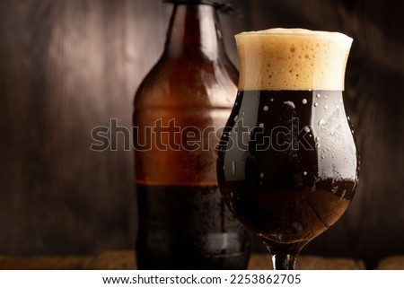 Brown porter on dark rustic background, english dark beer. Сток-фото © 
