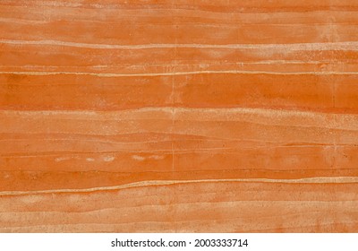 Brown Rammed earth wall grunge texture background. Compacted clay wall with layers of different colored incorporation striations of natural earth tone colors creates a warm, nature-friendly atmosphere - Shutterstock ID 2003333714