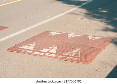 Brown Rectangular Speed Bump Installed On The Road. City. Jump. Safety. Traffic. Lying. Bumpy. Ramp. Roadway. Mark. Pass. Protection. Transportation. Stop. Surface. Danger