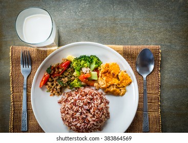 Brown rice with side dish and milk.Five food groups.