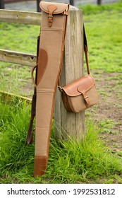 Brown Rifle Case And Matching Brown Bag In The Countryside.