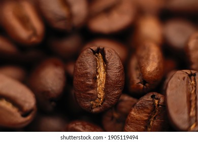 Brown Roasted Coffee Beans, Seeds On A Dark Background. Espresso Dark, Aroma, Black Caffeine Drink. Close Up Of Isolated Energy Mocha, Cappuccino Ingredient.