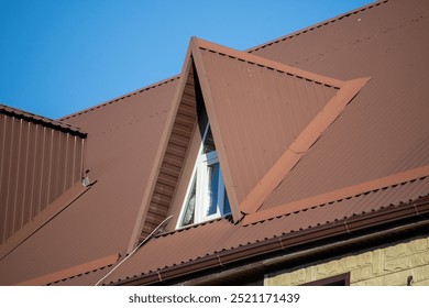 A brown roof with a window in the middle. The window is rectangular and has a white frame. The roof is slanted and has a triangular shape