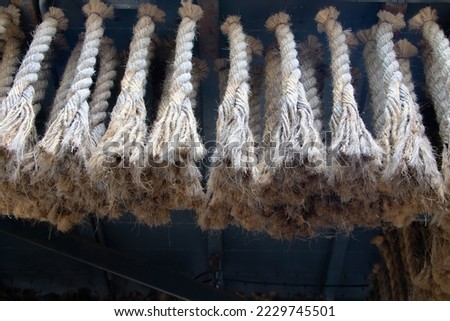Brown rope twine hangs many lines under ceiling.  Used to decorate the house or restaurant. suitable for backdrop, wallpaper, pattern concept. Abstract shape for interior, exterior design. 