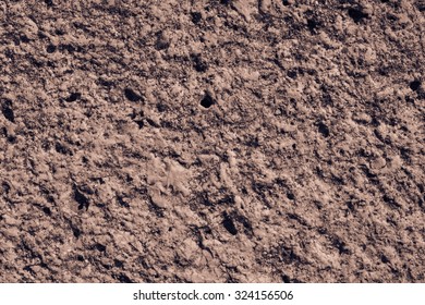 brown rough abrasive texture of a surface of a stone for empty and pure abstract backgrounds and for wallpaper