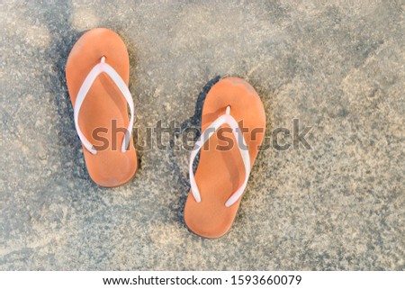 Brown sandals on a cement floor, comfortable to wear at a high angle.