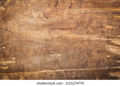 Brown scratched wooden cutting board background. Wood texture