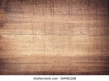 Brown scratched wooden cutting board. Wood texture - Shutterstock ID 569481268