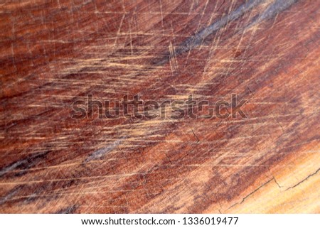 Brown scratched wooden cutting board. Wood texture