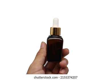 The Brown Serum Bottle Was In The Palm Of His Hand