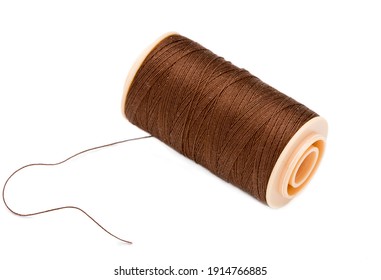 Brown Sewing Threads Spool With Loose Thread On White Background
