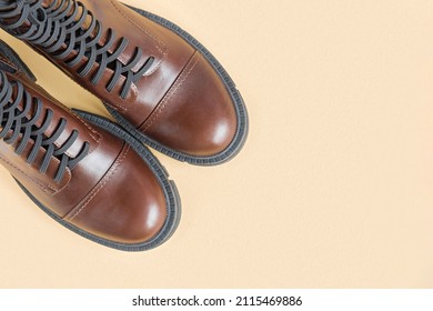 Brown Shoes. Trendy Boots Pair On Neutral Beige Background. Copy Space, Top View, Flat Lay. Shoe Sale, Fashion Concept. Stylish Casual Shoes For City. Overhead Shot Of Chelsea Boots. Urban Lifestyle.