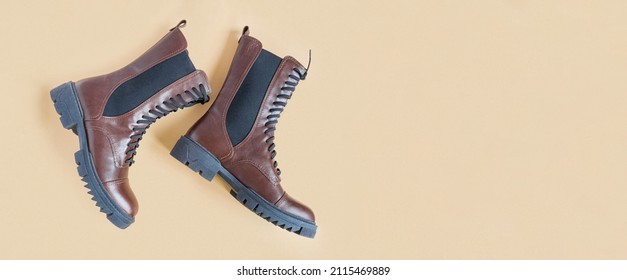 Brown Shoes. Trendy Boots Pair On Neutral Beige Background. Copy Space, Top View, Flat Lay. Shoe Sale, Fashion Concept. Stylish Casual Shoes For City. Overhead Shot Of Chelsea Boots. Urban Lifestyle.