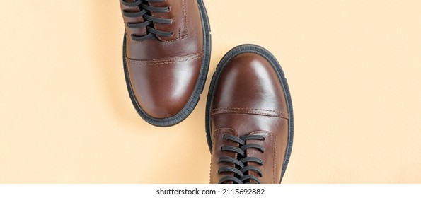 Brown Shoes. Trendy Boots Pair On Neutral Beige Background. Copy Space, Top View, Flat Lay. Shoe Sale, Fashion Concept. Stylish Casual Shoes For City. Overhead Shot Of Chelsea Boots. Urban Lifestyle.