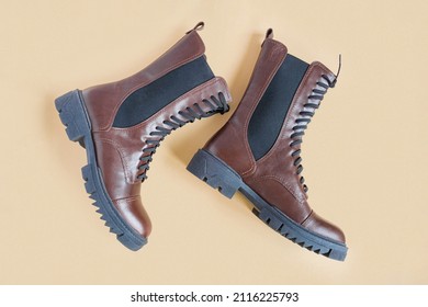 Brown Shoes. Trendy Boots Pair On Neutral Beige Background. Copy Space, Top View, Flat Lay. Shoe Sale, Fashion Concept. Stylish Casual Shoes For City. Overhead Shot Of Chelsea Boots. Urban Lifestyle.