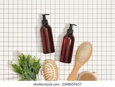 Brown shower gel dispensers, wooden combs for hair care. Round wooden brush for anticellulite massage with natural bristles, top view.