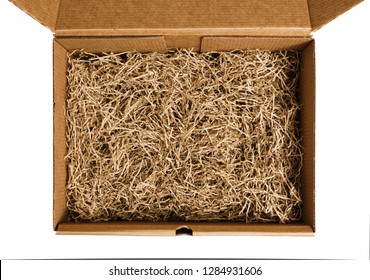Brown shredded paper for gifting and stuffing in cardboard box. Top view.