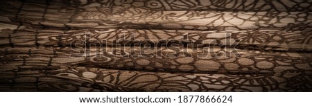 Brown silk fabric, floral pattern. Wavy corrugation. Fine wave on the surface of the fabric. Background texture, decorative ornament