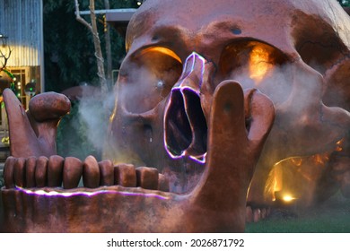 A Brown Skull Spinner Has Yellow Eyes And White Smoke.