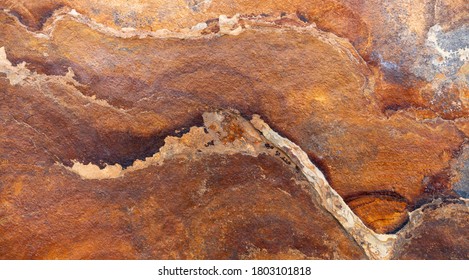 Brown slate stone slab with abstract pattern in close-up