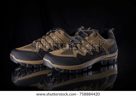 Brown Sneaker on Black Background, isolated product, comfortable footwear.