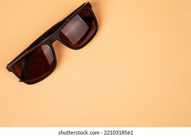 Brown Solar Safety Glasses Closeup On A Beige Background Top View With Copy Space.