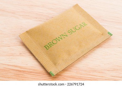 Brown Sugar Bag On Wood Background