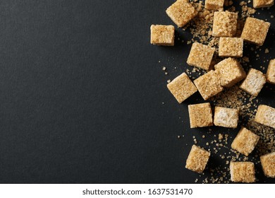 Brown Sugar Cubes On Black Background, Top View