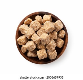 Brown Sugar Cubes On A Wooden Plate Set Against A White Background. View From Directly Above.