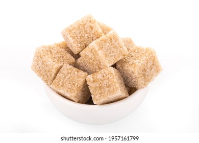 brown sugar cubes. brown sugar in white bowl on white background. sugar cubes, cane sugar