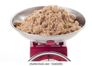 Brown Sugar In Silver Bowl On Top Of  Weighing Scales