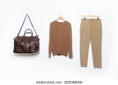 Brown Sweater With Khaki Pants On Hanging With Handbag 

