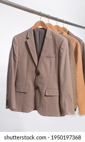 Brown Sweatshirt ,sweater ,brown Suit ,jacket  Hanging On Wooden Clothes Hanger