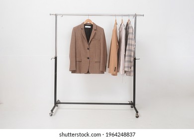 Brown Sweatshirt ,sweater ,brown Suit ,jacket  Hanging On Wooden Clothes Hanger