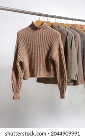 Brown Sweatshirt ,sweater ,brown Suit ,jacket  Hanging On Wooden Clothes Hanger