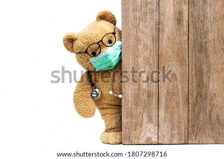 Brown teddy bear doctor with protective medical facemask and stethoscope. Quarantine coronavirus pandemic protection,  covid concept.