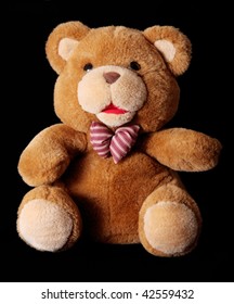 Brown Teddy Bear Over Black Background. Toy