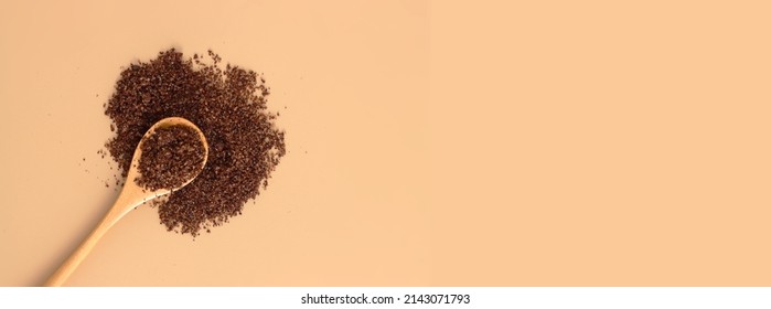 Brown Texture Scrub With Cocoa Coconut Coffee In Wooden Spoon On Brown Background. Spa And Home Care Concept, Banner, Copyspace