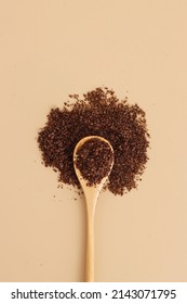 Brown Texture Scrub With Cocoa Coconut Coffee In Wooden Spoon On Brown Background. Spa And Home Care Concept, Beauty Procedures, Vertical Photo