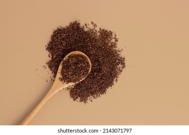 Brown Texture Scrub With Cocoa Coconut Coffee In Wooden Spoon On Brown Background. Spa And Home Care Concept, Beauty Procedures