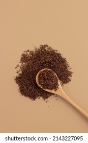 Brown Texture Scrub With Cocoa Coconut Coffee In Wooden Spoon On Brown Background. Spa And Home Care Concept, Beauty Procedures, Vertical Photo