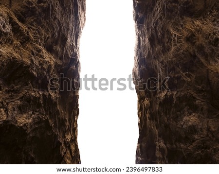 Brown textured stone walls in a dark rocky gorge tunnel