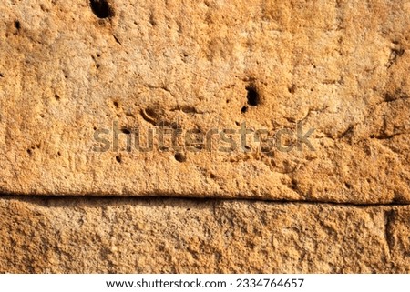 brown tint stone texture of stone background Abstract relief rough gritty brown surface of background texture.