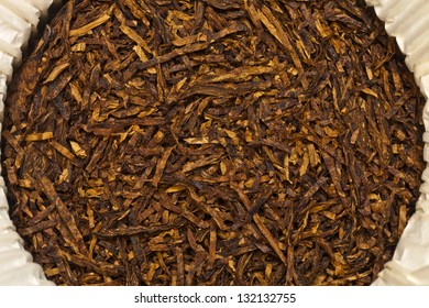 Brown tobacco pipe smoking close-up