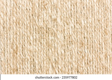 Brown twisted rope pattern background. Natural fiber cords in parallel lines. Textured string surface for nautical or craft themes. Organic rough detail. Rustic material structure in closeup.