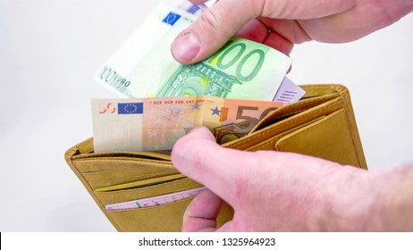 A brown wallet with 650 Euro bills. The bills consisted with a 500 100 and 50 Euro bills then the man threw it on the table