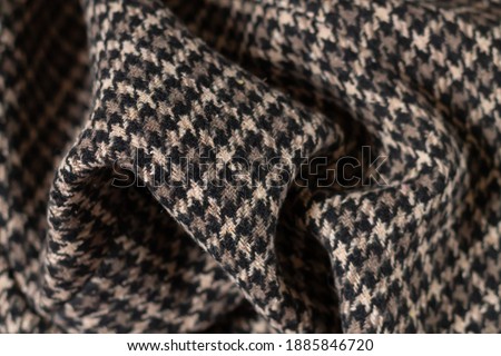 Brown warm wool fabric swatch houndstooth. Woven dogstooth check design background
