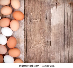 Brown And White Eggs On A Rustic Wooden Plank