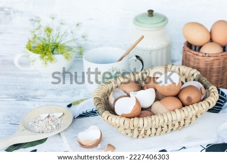  Brown and white eggshells placed in basket in home kitchen on table, eggshells stored for making natural fertilizers for growing vegetables, sustainability concept